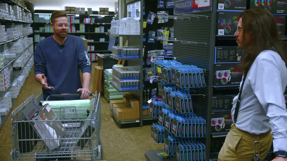 The Micro Center read in Basically Homeless's aim assist video, filmed in a store aisle with a cart of PC parts, August 2025